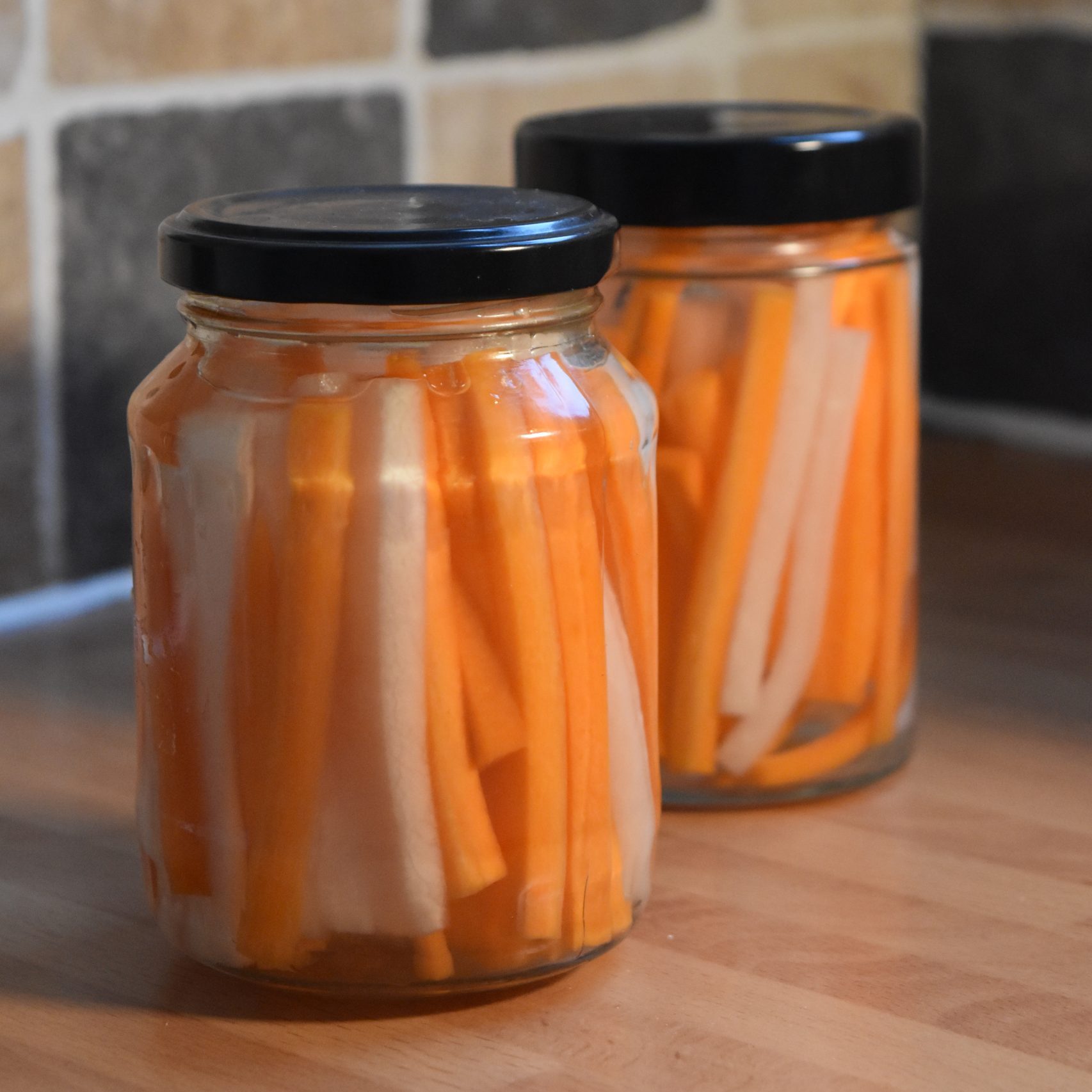 Pickled carrots and radish in jars