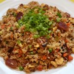 the best fried rice on a white place on yellow table.