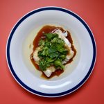 cantonese style cod with ginger and spring onion on plate