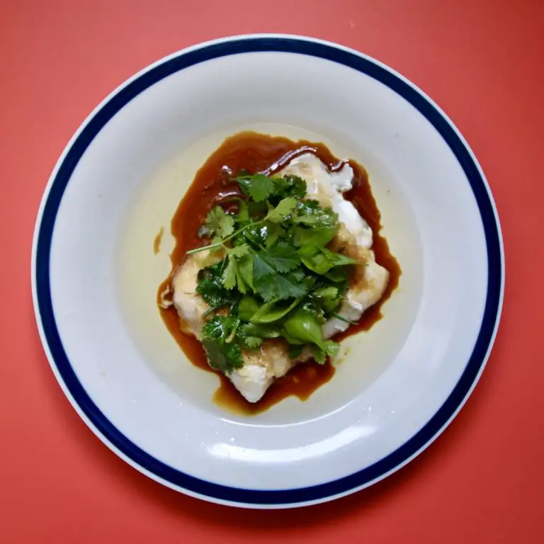 cantonese style cod with ginger and spring onion on plate