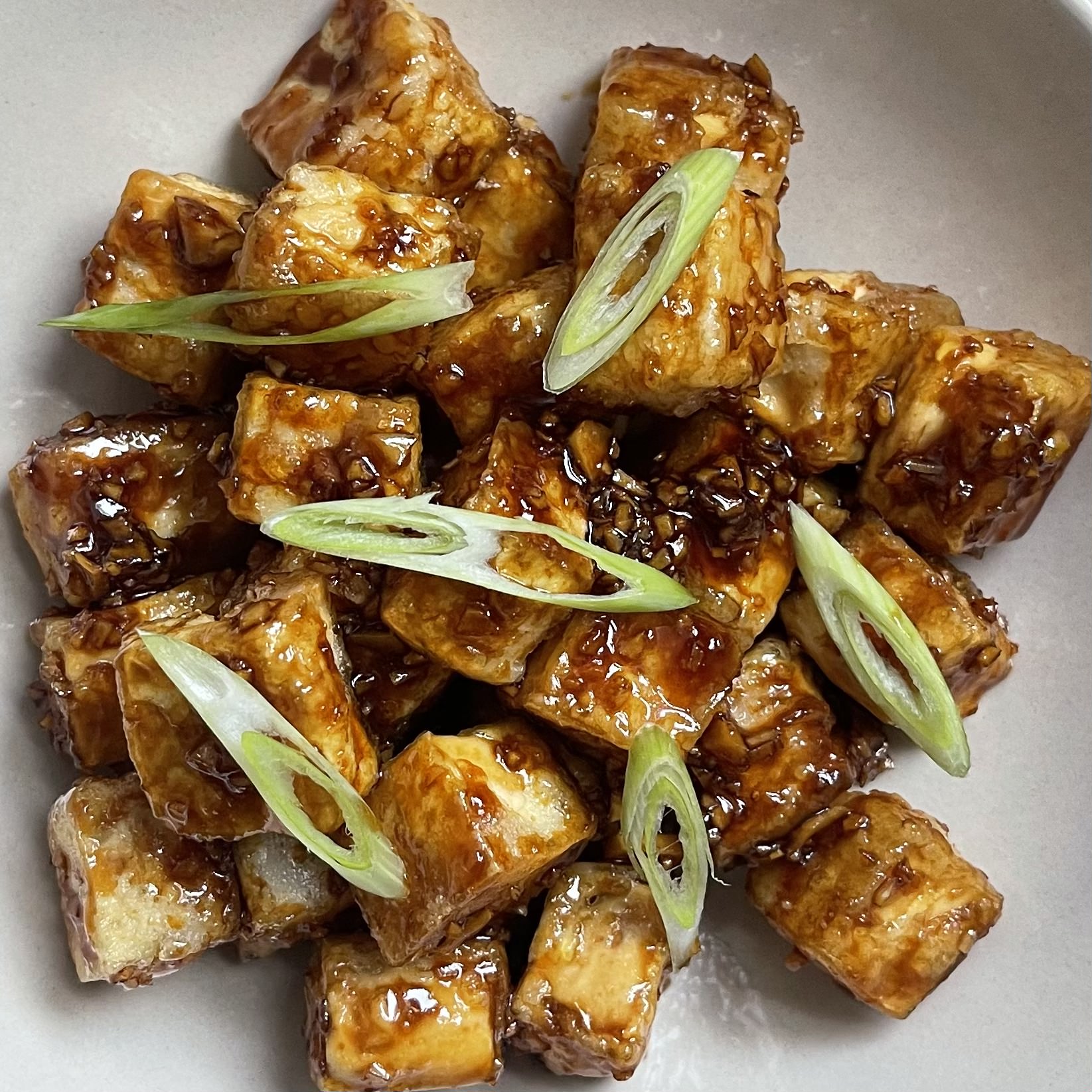 crispy honey and garlic tofu bites on a plate